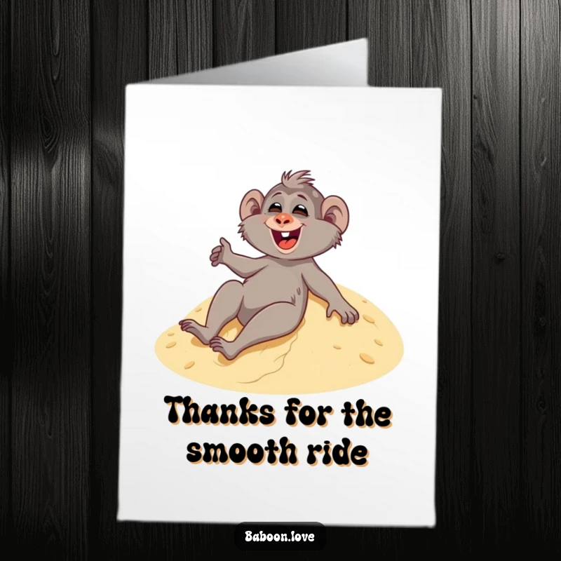 Funny Free Printable Thank You Card depicting a delighted baboon giggling while sliding down a sandy dune, expressing thanks with a smile.